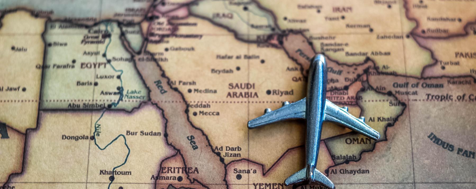 Plane model on Saudi Arabia part of world map.