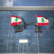 Plane flying over Lebanon flags