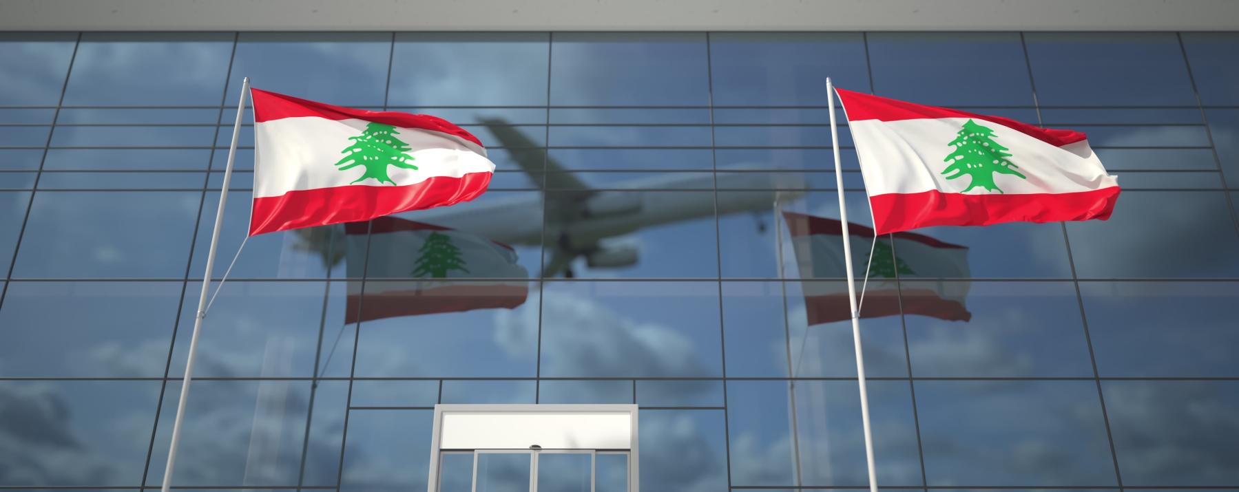 Plane flying over Lebanon flags